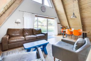 a living room with a couch and a table at A-Frame Hideaway in Neskowin