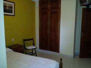 A bed or beds in a room at Hostal Atila