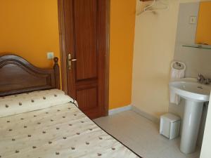 A bed or beds in a room at Hostal Atila