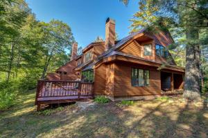 a log cabin in the woods with a deck at Birch Landing #16 in Plymouth