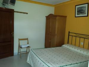 A bed or beds in a room at Hostal Atila