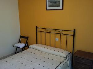 A bed or beds in a room at Hostal Atila