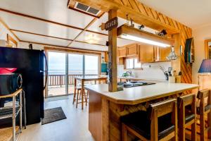 a kitchen with a view of the ocean at Happy Camp Beachfront Cabin in Netarts