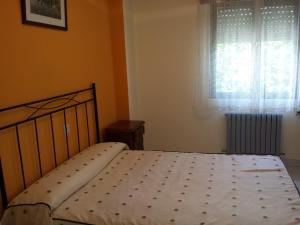 A bed or beds in a room at Hostal Atila