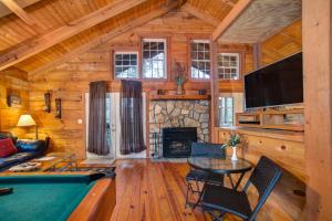 a living room with a pool table and a fireplace at Shasta in Sautee Nacoochee