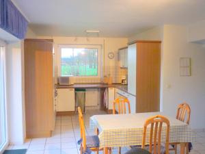 a kitchen and dining room with a table and chairs at Hallmannshof in Sonsbeck