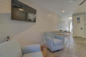 a living room with two chairs and a television on the wall at 104 Inlet Sands Condo in Inlet Beach