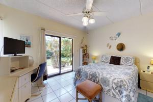 a bedroom with a bed and a tv and a window at Ventura in South Padre Island