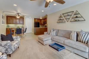 a living room with a couch and a table at North Coast Village Retreat in Oceanside