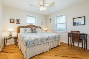 a bedroom with a bed and a ceiling fan at Beach Oasis in Galveston