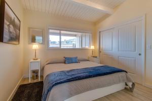 a bedroom with a bed and a window at Surfside Suite On The Sea, Too in Gearhart