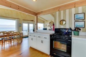 a kitchen with a stove and a dining room at Oceanfront Dream in Cayucos