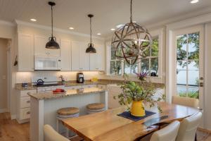 a kitchen with a wooden table and a dining room at Orcas Beach Cottage in Eastsound