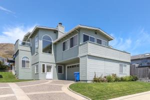 a house with a blue and white at Ocean Mornings in Cayucos