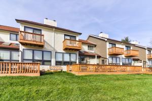 a large apartment building with balconies and a yard at Ski Harbor #15 in McHenry