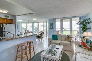 a living room with a couch and a table at Dunes on the Bay in Pensacola Beach