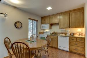 a kitchen with a wooden table and a table and chairs at 14 Antelope Lane in Sunriver
