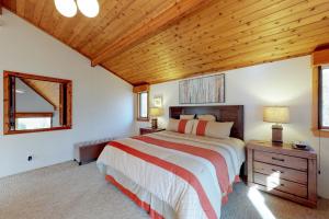 a bedroom with a bed and a wooden ceiling at South Hill Lodge in Ludlow