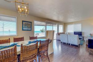 a dining room with a table and chairs and a living room at Blue Door Retreat in Cayucos
