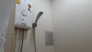 a phone on a wall in a bathroom at Cha-Am Fish Star Hotel in Cha Am