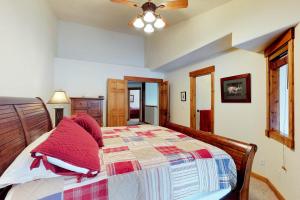 a bedroom with a bed with red pillows on it at Aspen Village 86 in McCall +27 photos