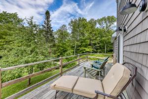 a porch with chairs and a view of the woods at Andover Retreat in Ludlow