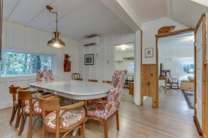 a kitchen and dining room with a table and chairs at Renee's Log House in McKenzie Bridge