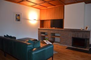 a living room with a couch and a fireplace at Ferienhaus Mätzler in Schwarzenberg