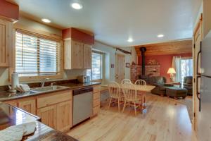 a kitchen with wooden cabinets and a table with chairs at 13 Deer Lane in Sunriver