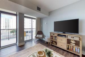 a living room with a large flat screen tv at Braemar Towers 209 in Ocean City