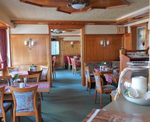 a dining room with wooden tables and chairs at Hotel Clemens in Winterberg