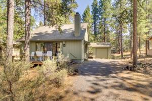 a small green house in the middle of a forest at 13 Deer Lane in Sunriver