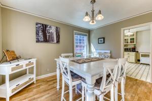 a dining room with a white table and chairs at Washburne Park Retreat in Eugene