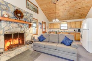 a living room with a couch and a fireplace at Moss Creek Cabin in Morganton
