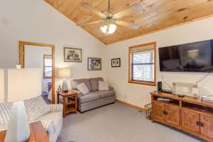 a living room with a couch and a flat screen tv at Moss Creek Cabin in Morganton