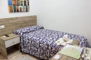 Ένα ή περισσότερα κρεβάτια σε δωμάτιο στο Pensión Guerrero