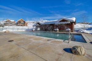 una piscina frente a una casa en la nieve en First Tracks Fun, en Steamboat Springs