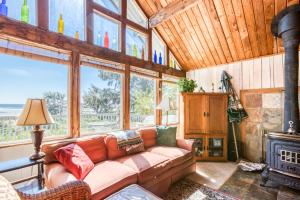 a living room with a couch and a fireplace at Rocks Cabin in Copalis Beach