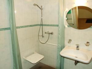 a bathroom with a sink and a shower at Ferienwohnungen Am Seeufer 11 in Waren +28 photos