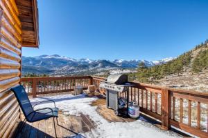 a grill on a deck with a view of mountains at High Pines Cabin in Estes Park