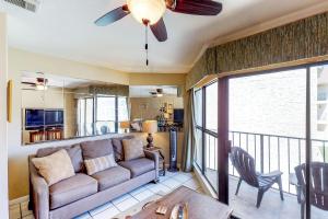 Una sala de estar con un sofá y un balcón. en Gulfside Townhome #16, en Gulf Shores
