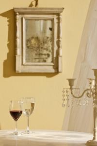 two glasses of wine sitting on a table at Tamarix Del Mar Suites in Kamari