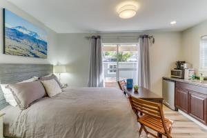 a bedroom with a bed and a desk and a kitchen at Mercer Island- Mt Saint Helens Room in Mercer Island