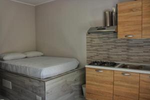 a small bedroom with a bed and a stove at Lo Spillo in Pineto