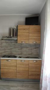 a kitchen with wooden cabinets and a stove at Lo Spillo in Pineto +30 photos