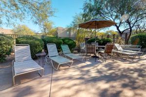 a group of chairs and an umbrella on a patio at Village at Carefree in Carefree