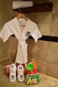 a white shirt on a hanger next to some toys at Princess Family Club Riviera - All Inclusive in Playa del Carmen