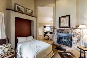 a bedroom with a bed and a fireplace at Aspenwood 4262 in Pagosa Springs