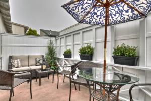 a patio with chairs and a table with an umbrella at Monterey B in San Clemente