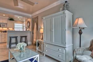 a living room with a large cabinet and a table at Monterey B in San Clemente